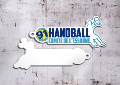 Porte-clés en PVC 2D personnalisé fabriqué pour le Comité Départemental de Handball de l'Essonne, mettant en avant le logo et les couleurs du comité.